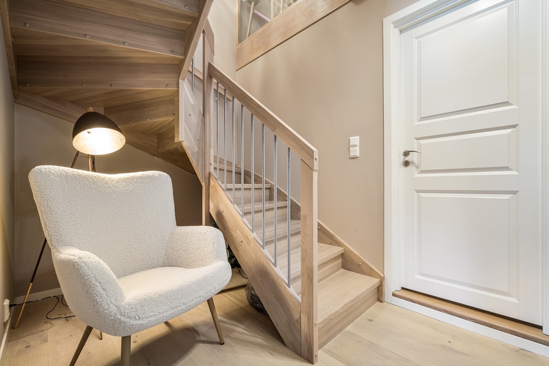 A white chair sitting next to a white door