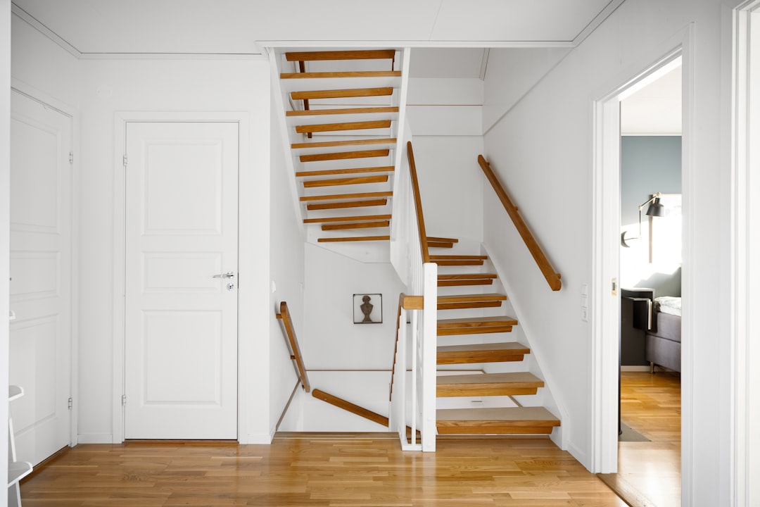 A room with a stair case and a wooden floor