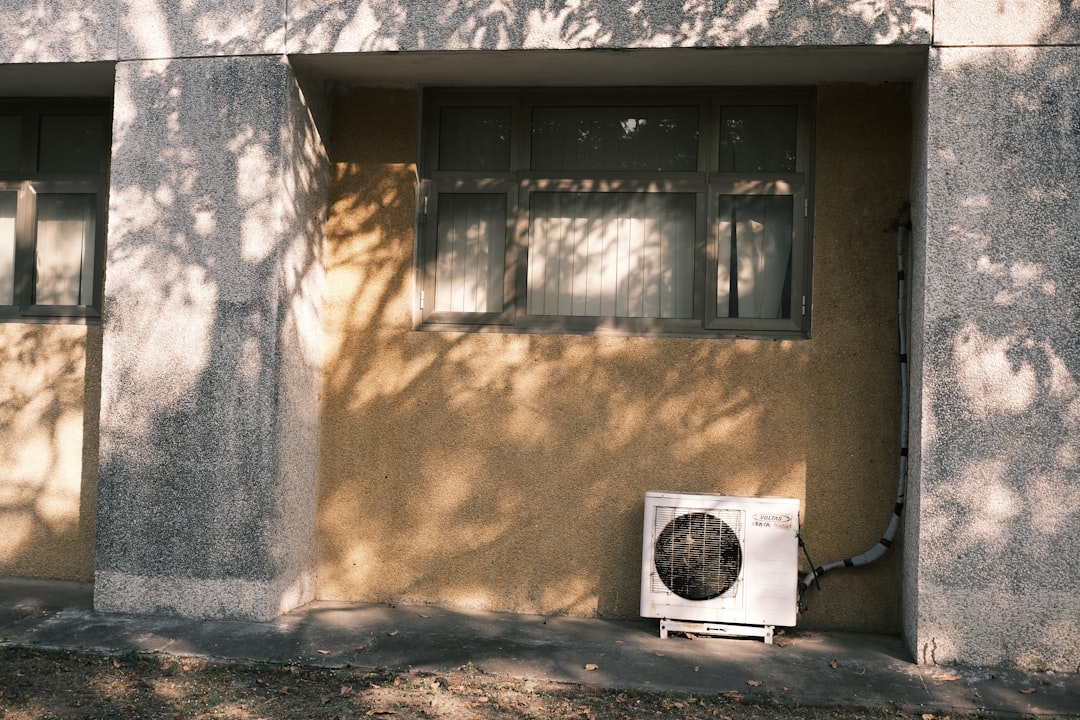 an air conditioner sitting on the side of a building