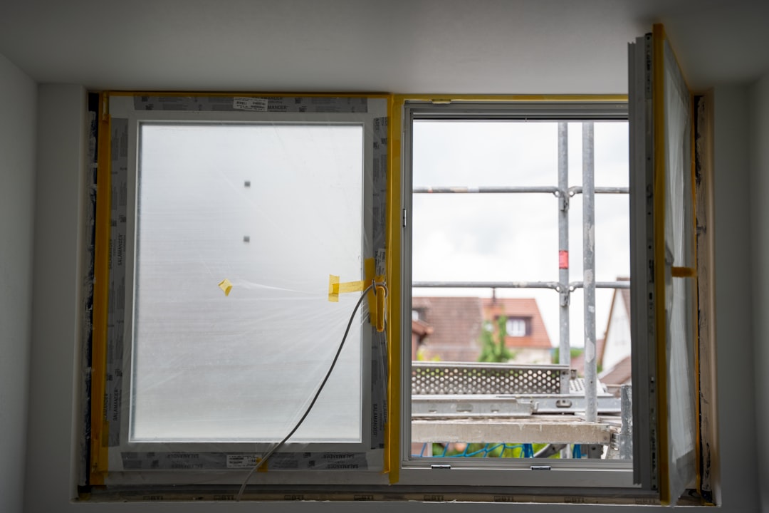Open window with construction happening outside.