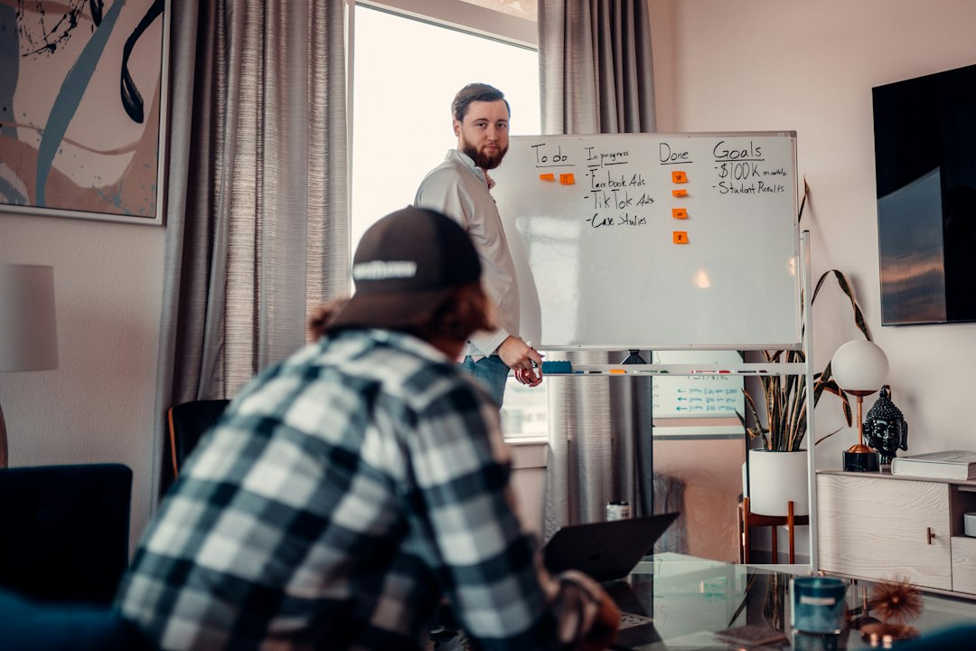 a man standing in front of a whiteboard in a living room