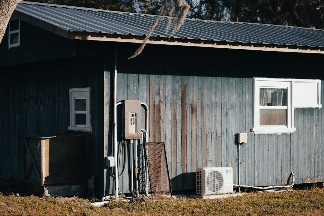 a small building with a gas pump next to it