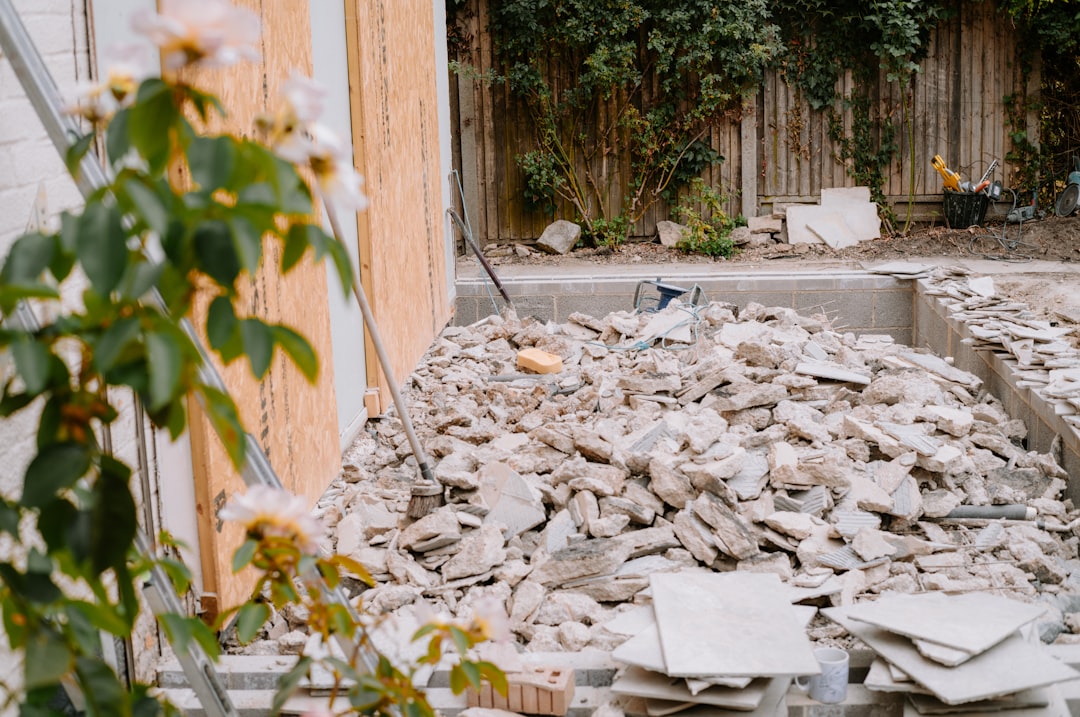 A pile of broken concrete rubble in a backyard construction site